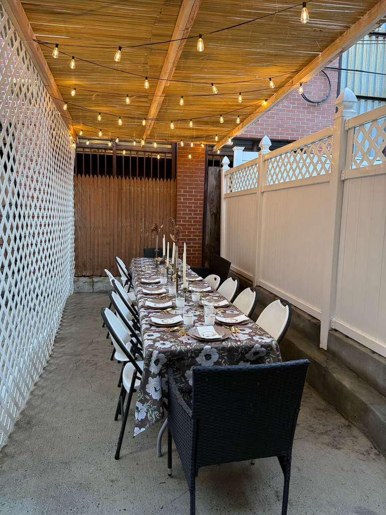 Sukkah set for a meal with string lights