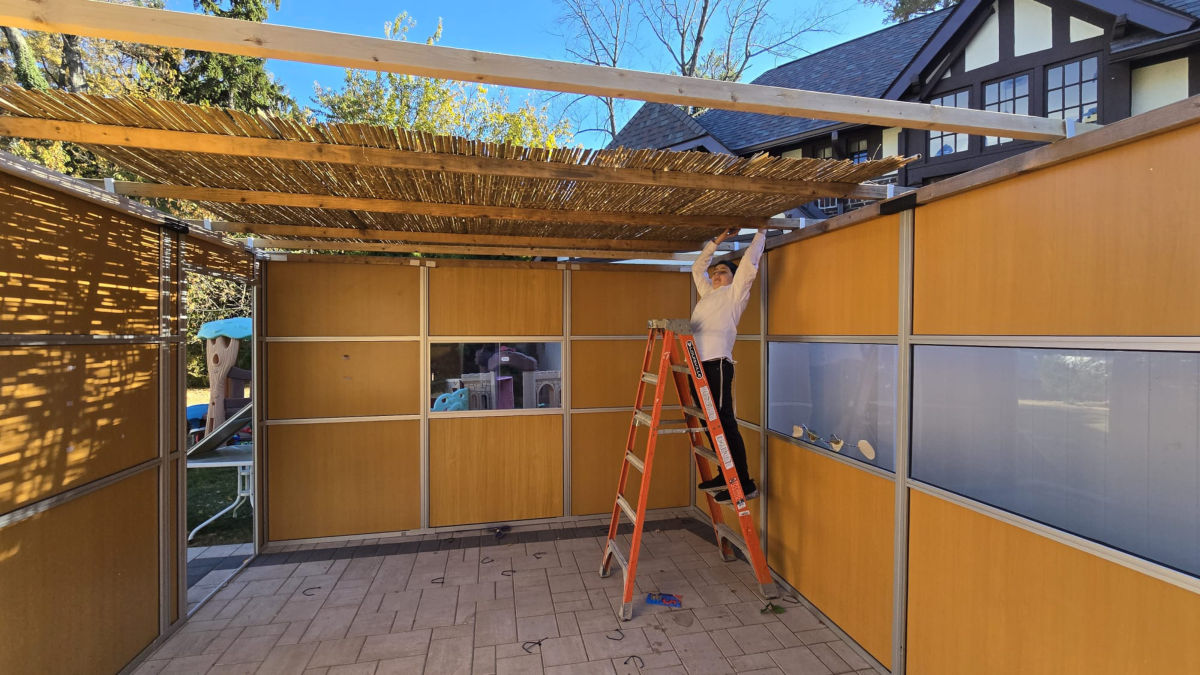 Putting up schach on a panel sukkah
